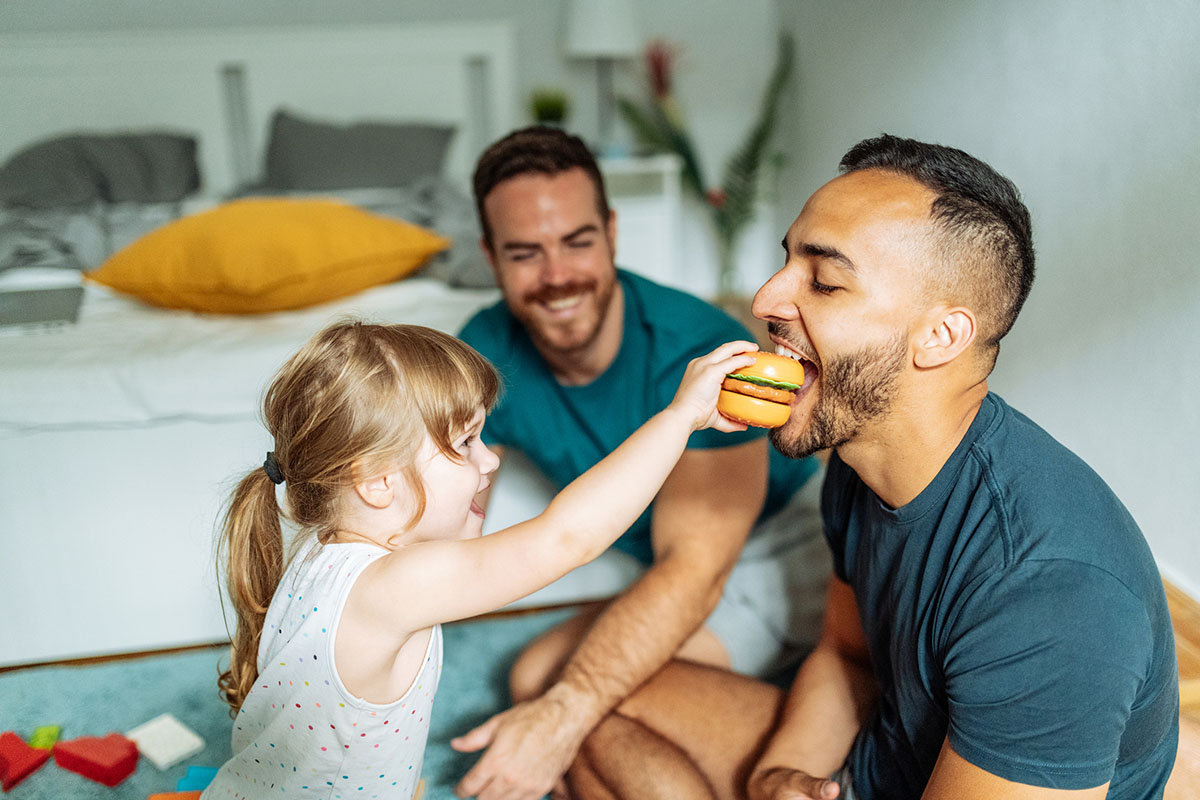 Male parents with daughter playing