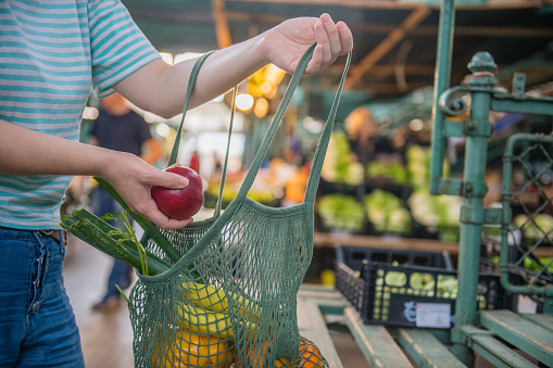 Woman at grocery store buying produce
