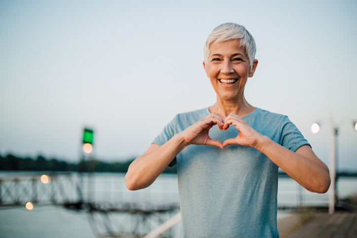 a woman making a heart with her hands