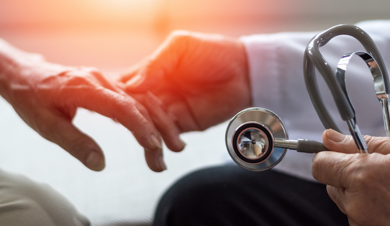 doctor holding a patient's hand