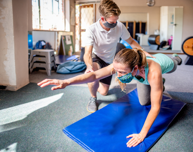 a woman performing an exercise in physical therapy