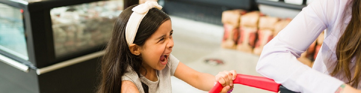 tired mother on couch between two blurred images of active children