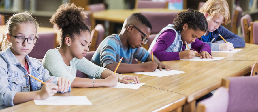 five kids writing in class