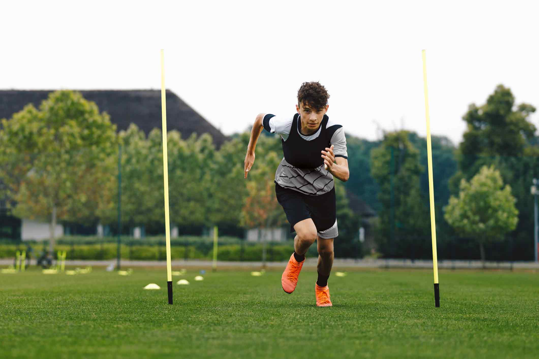 Teenage boy doing warmups on a sports field