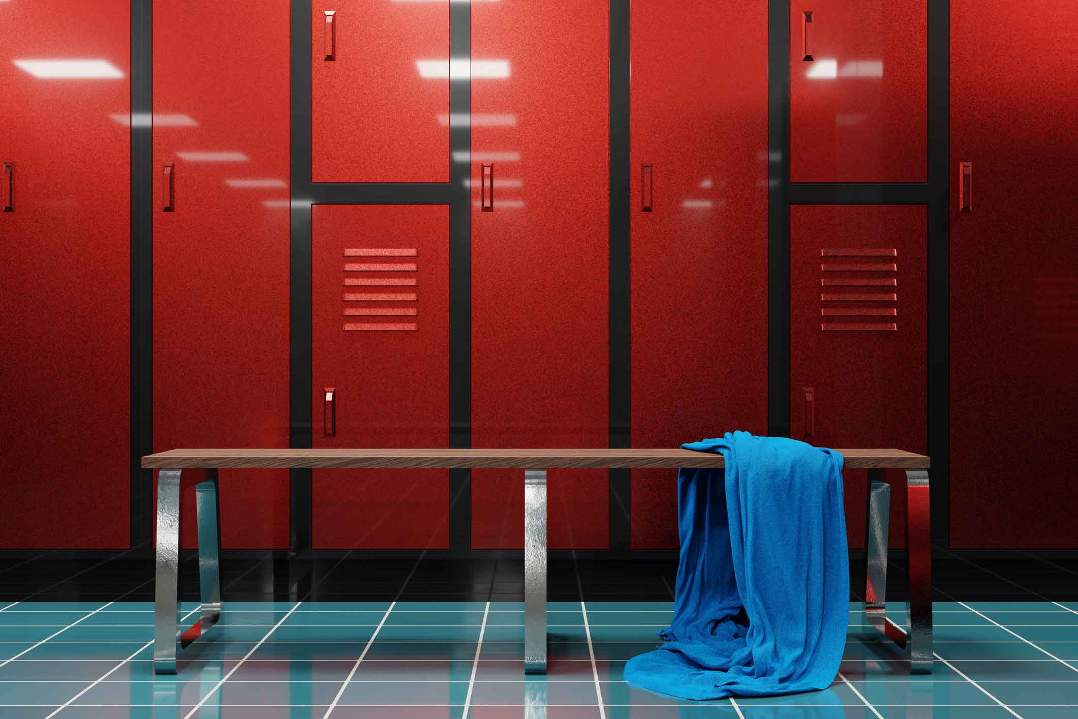 Inside of a locker room with a towel laying on a bench